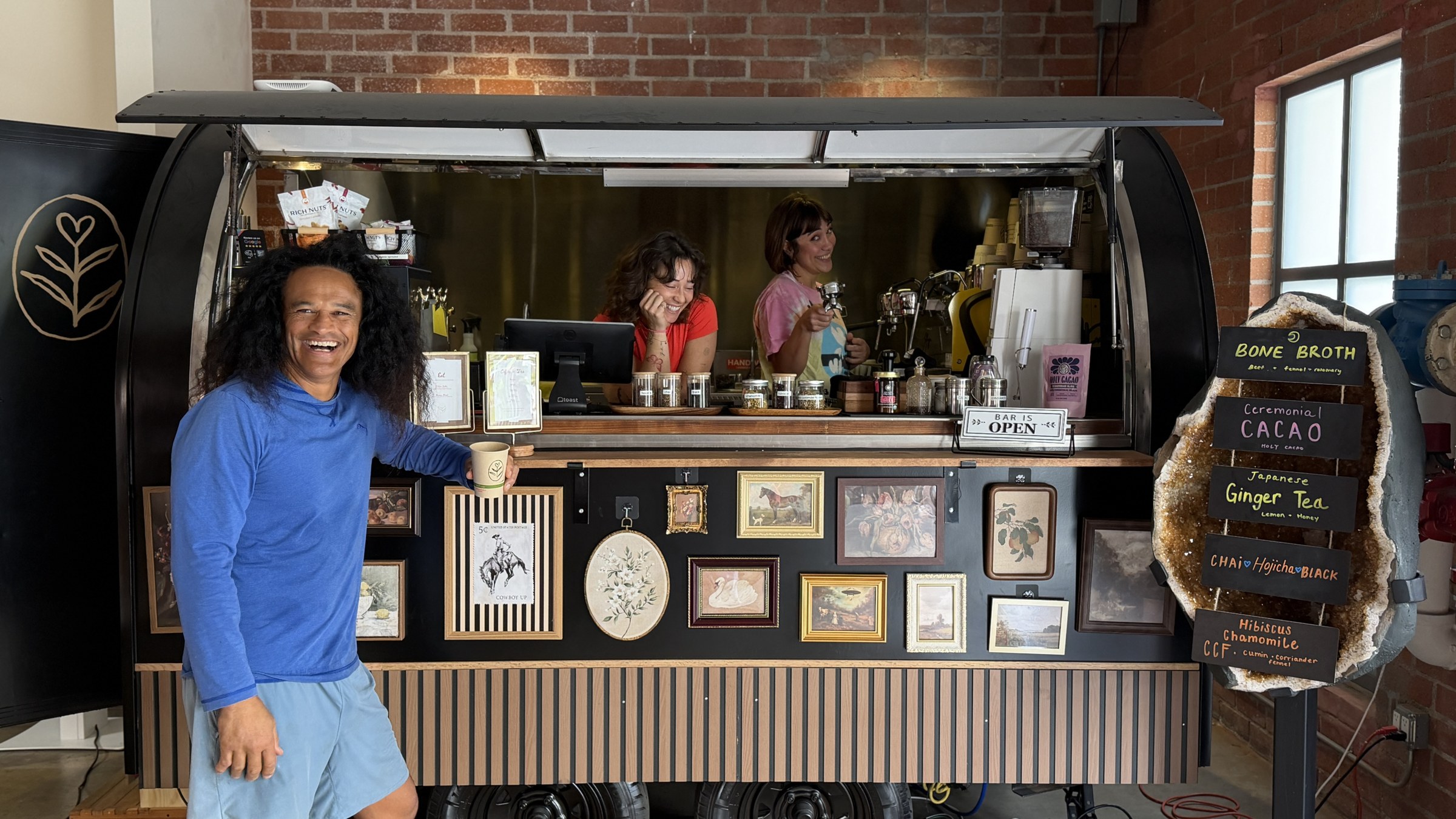 The Cherish coffee bar inside the studio, baristas laughing behind the counter